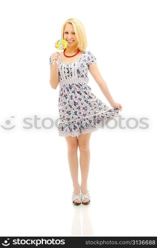 Attractive blonde with lollipop holding her dress, looking like a littile girl