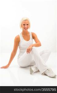 Attractive blonde woman relaxing during Pilates exercise on white background