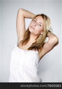 Attractive blonde woman with no make up gray background