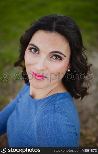 Attractive brunette girl in the park with blue jersey