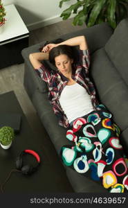 Attractive brunette girl sleeping on the sofa. View from above