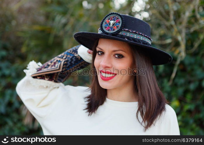 Attractive brunette girl with elegant black hat