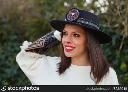 Attractive brunette girl with elegant black hat
