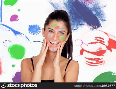 Attractive brunette girl with her face painted and a colorful background
