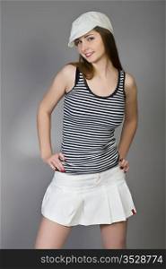 attractive brunette in a white cap and a striped vest