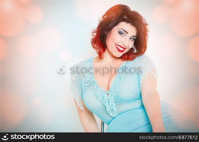 attractive brunette in blue dress on an abstract background