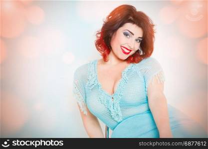 attractive brunette in blue dress on an abstract background