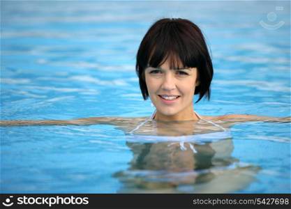 Attractive brunette in pool