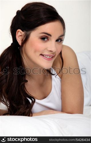 Attractive brunette laying in bed