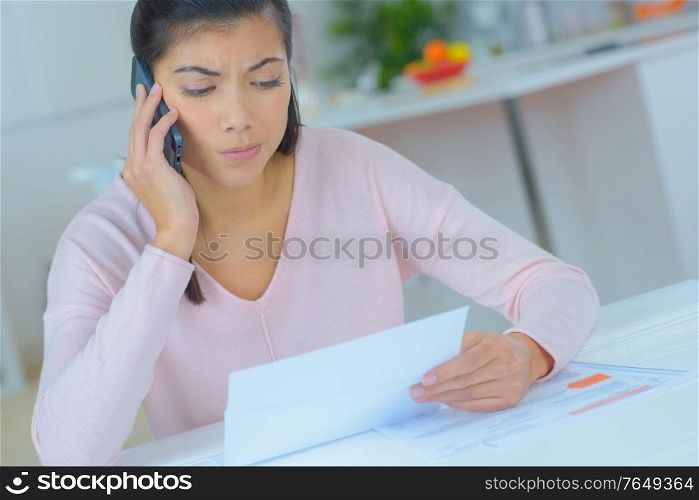 attractive brunette on phone with worried facial expression
