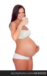 Attractive brunette pregnant in underwear drinking milk and milk isolated on a white background