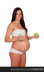 Attractive brunette pregnant in underwear eating apple and milk isolated on a white background