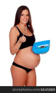 Attractive brunette pregnanta in underwear eating salade isolated on a white background