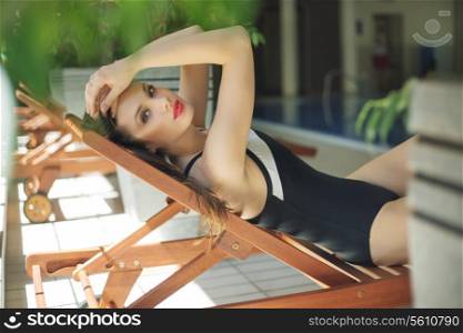 Attractive brunette resting on the deckchair
