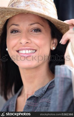 Attractive brunette wearing straw hat