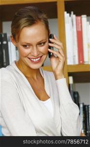 Attractive business woman in white shirt using mobile phone
