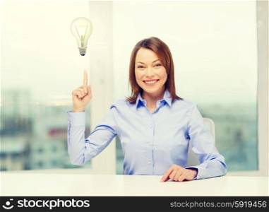 attractive businesswoman at office. business and office concept - smiling businesswoman pointing finger up in office