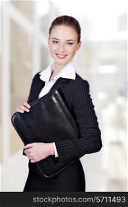 Attractive businesswoman holding the black folder
