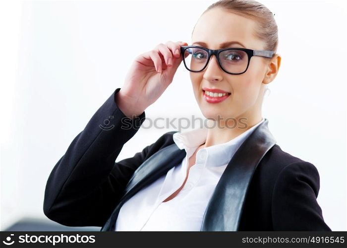 Attractive businesswoman in black suit. Image of young businesswoman in glasses wearing black suit