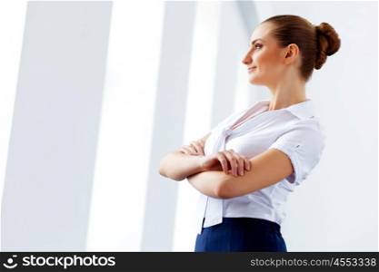 Attractive businesswoman in business suit. Image of young businesswoman in business suit with arms crossed