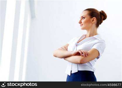 Attractive businesswoman in business suit. Image of young businesswoman in business suit with arms crossed