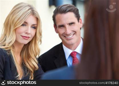 Attractive Businesswoman in Meeting with Colleagues