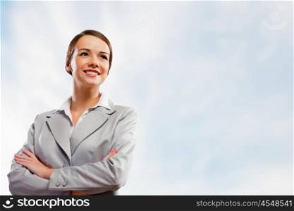Attractive businesswoman in suit. Image of attractive businesswoman smiling with arms crossed