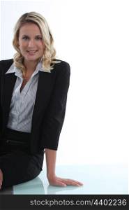 Attractive businesswoman leaning on a table