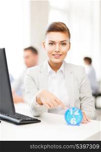 attractive businesswoman pointing at clock in office