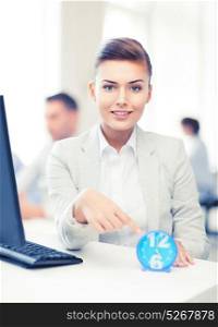 attractive businesswoman pointing at clock in office. businesswoman pointing at clock in office