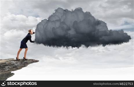 Attractive businesswoman pushing big cloud with effort. Computing concept