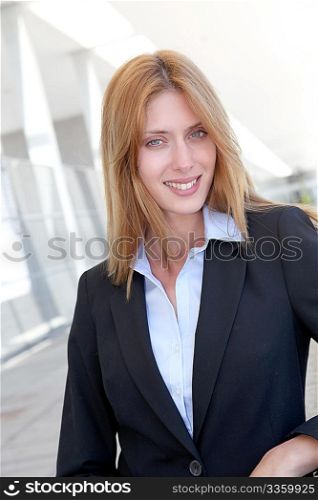 Attractive businesswoman standing outside a building
