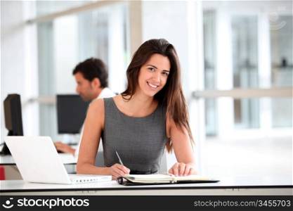 Attractive businesswoman working on laptop computer