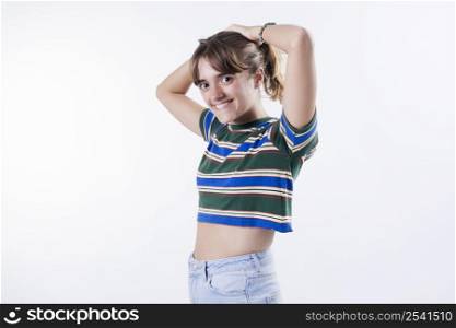 Attractive carefree relaxed modern young girlfriend wearing cropped top touch hair hold hands head loose standing joyful smiling pleased enjoy perfect party