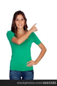 Attractive casual girl in green indicating something isolated on white