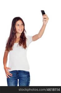 Attractive casual girl taking a photo with her mobile isolated on a white background