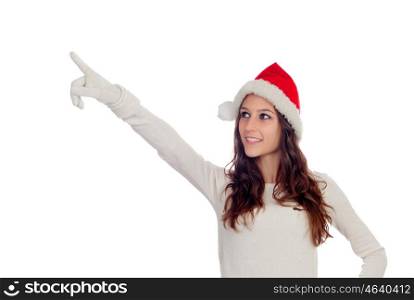 Attractive casual girl with Christmas hat pointing something isolated on a white background