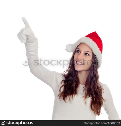 Attractive casual girl with Christmas hat pointing something isolated on a white background