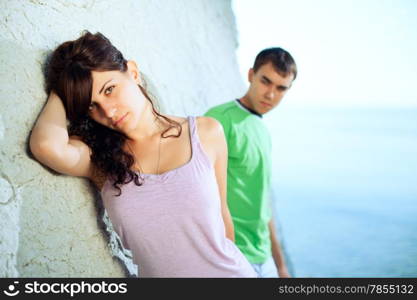 Attractive coupe on the seaside lean against the rock