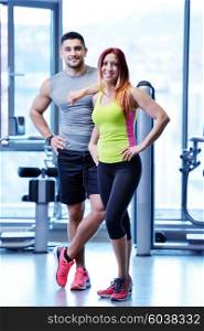 attractive couple at the gym looking happy