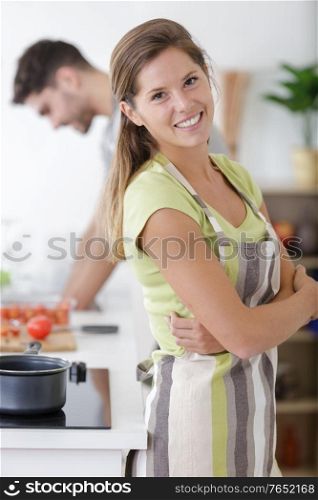 attractive couple cooking in kitchen