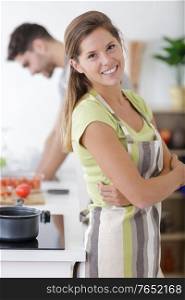 attractive couple cooking in kitchen