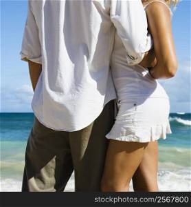Attractive couple in embrace on Maui, Hawaii beach.