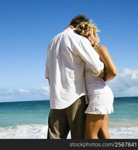 Attractive couple in embrace on Maui, Hawaii beach.