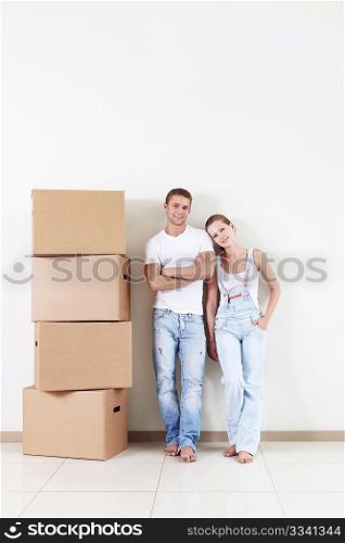 Attractive couple in the apartment with a cardboard box