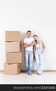 Attractive couple in the apartment with a cardboard box