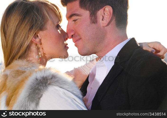 attractive couple is kissing on street at sunset