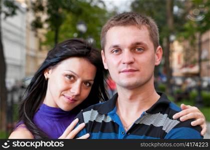 attractive couple is standing on city street