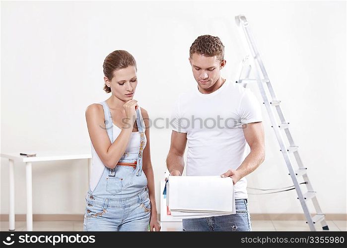 Attractive couple looking at blueprints of the new apartment