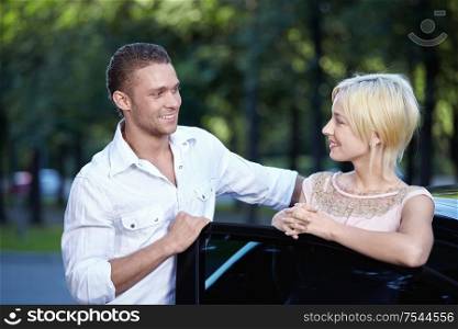 Attractive couple looking at each other in cars
